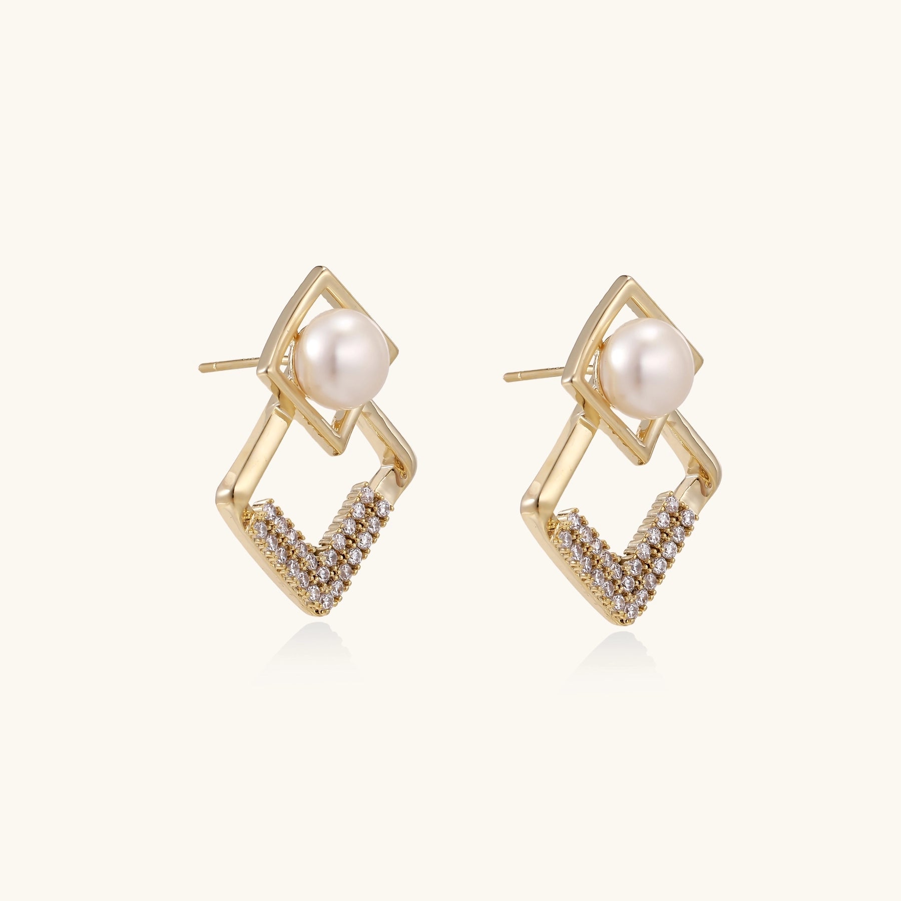 Gold-plated geometric drop earrings with freshwater pearls in square frames and crystal-accented diamond-shaped dangles