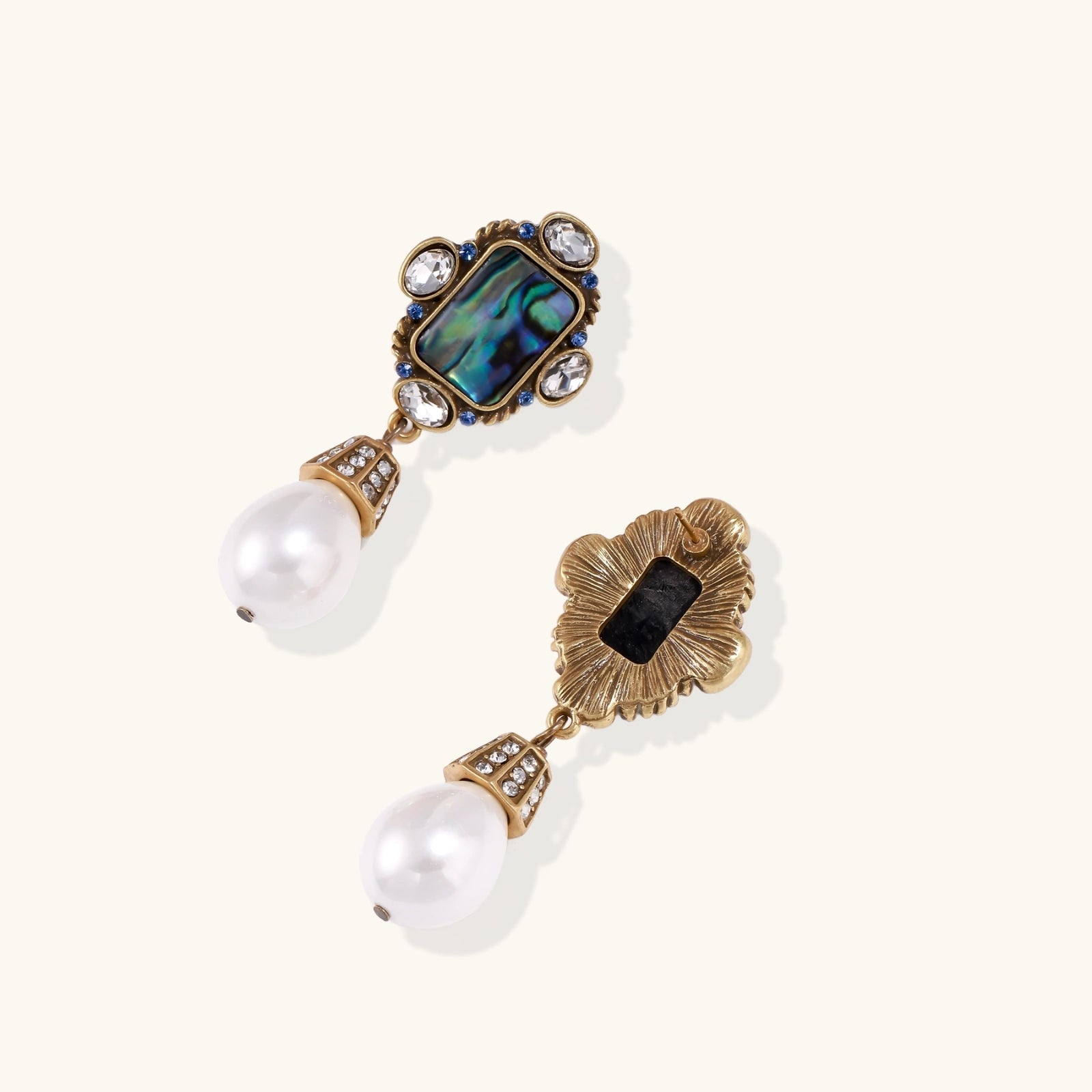 Ornate gold-plated drop earrings with rectangular abalone shell centers, crystal accents, and baroque pearl drops